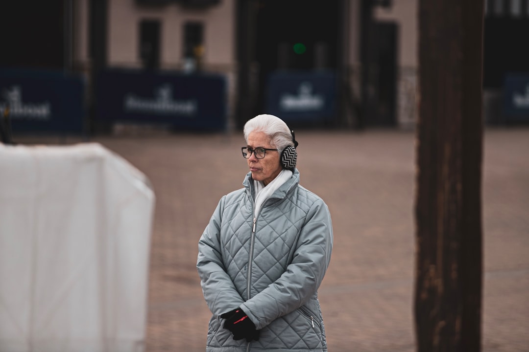 woman wearing earmuffs and quilted gray jacket