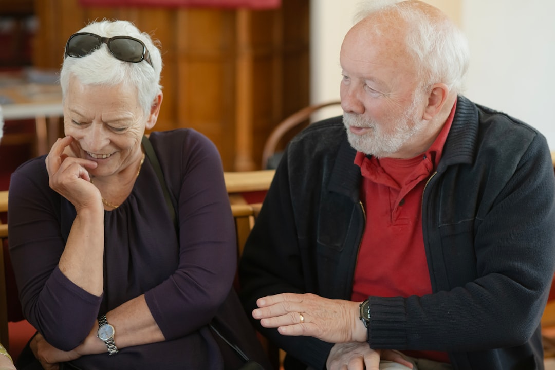 An older couple is talking and smiling.