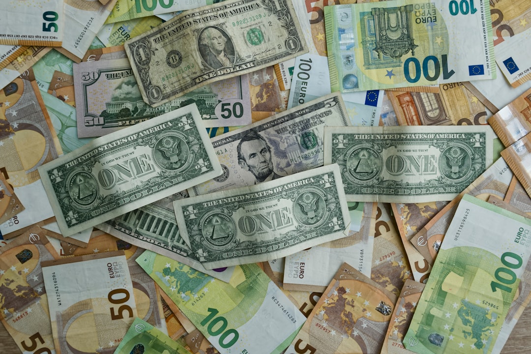 Us dollars and euros scattered on a surface.