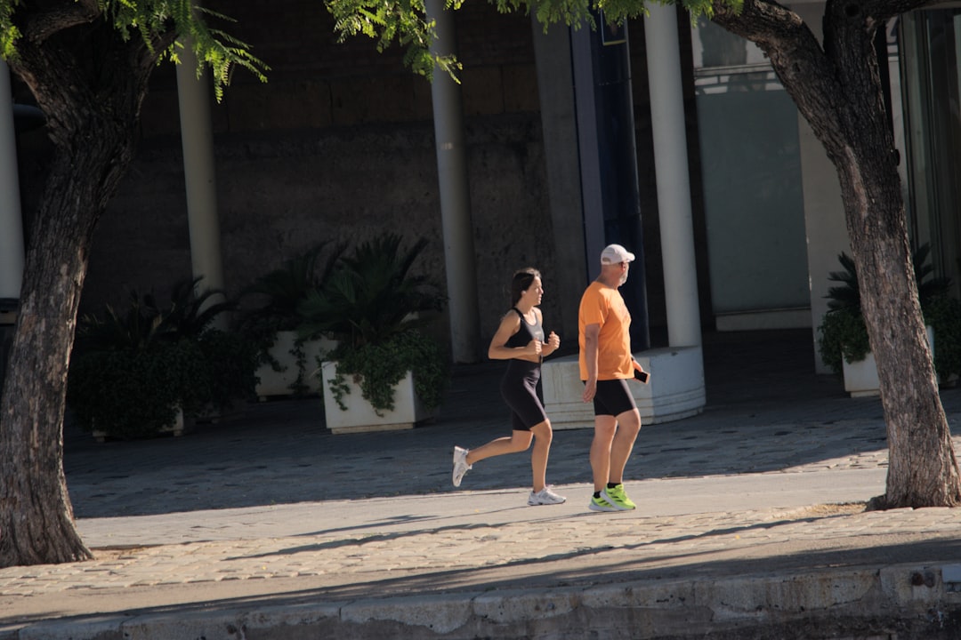 A man and a woman running down a street